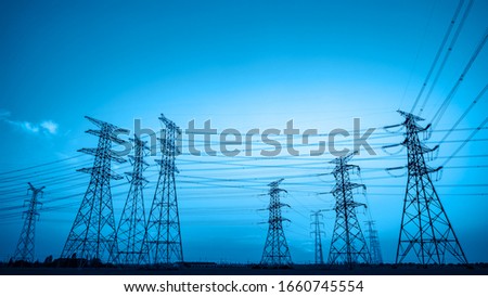 High voltage power tower and beautiful nature landscape at sunset Royalty-Free Stock Photo #1660745554