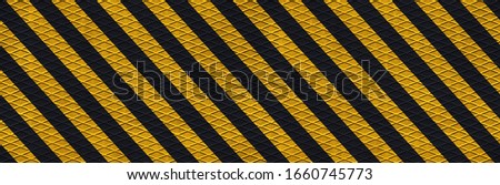 panoramic black and yellow safety hazard attention warning stripes on diamond metal texture