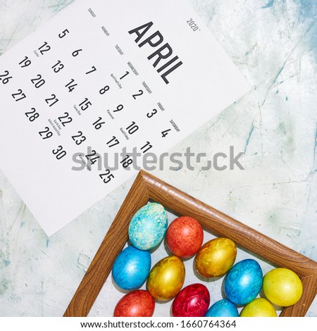 Monthly April 2020 calendar with colorful decorated Easter eggs. View from above. Top view. Easter holidays, festive, springtime concepts