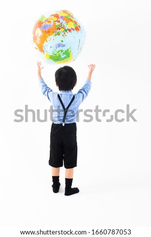 Portrait of boy in front of white wall