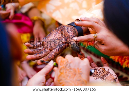 Indian wedding ceremony : groom hand with mehandi design 
