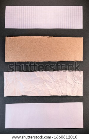 image of torn paper stripes with different textures on a black background