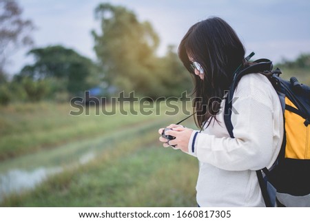 Asian women traveling alone with backpack and camera.Travel Holiday Relaxation Concept , Vintage Style.
