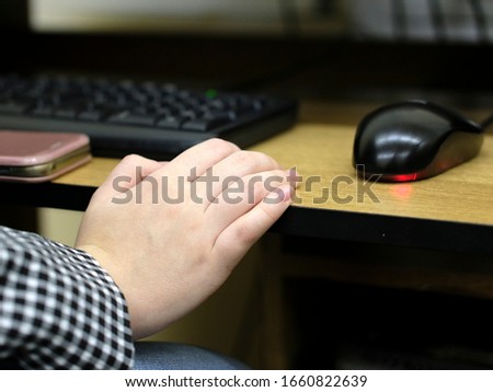image of a male hand near a computer mouse