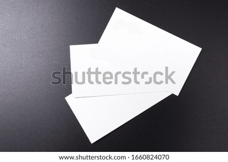 stacks of blank white business cards on a black surface. space for text