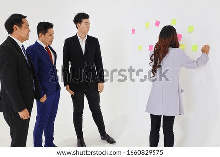 Young Asian business people meeting or talking or discussing or creative brainstorming in meeting room