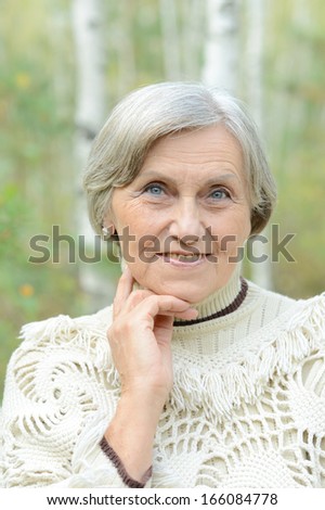 Beautiful portrait of an old woman on the autumn