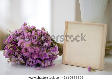 Wooden landscape frame mock up with a vase of purple flower beside the frame, overlay your quote, promotion, headline, or design, great for small businesses, lifestyle bloggers and social media