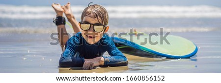 Young surfer, happy young boy at the beach with surfboard BANNER, LONG FORMAT