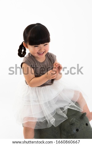 Portrait of girl in front of white wall