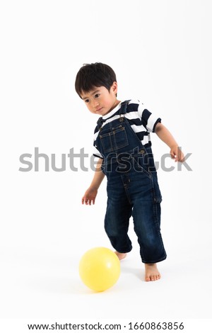 Portrait of boy in front of white wall