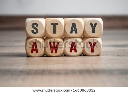 Cubes and dice with Stay Away on wooden background Royalty-Free Stock Photo #1660868812