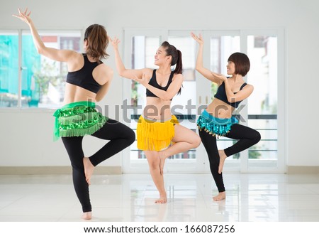 Image of beauty belly dancers performing in the dance studio  Royalty-Free Stock Photo #166087256
