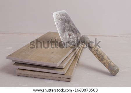 Trowel on the tiles for floors and walls