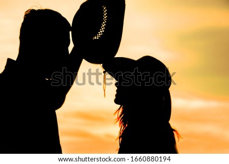happy couple together at sunset silhouette of natur