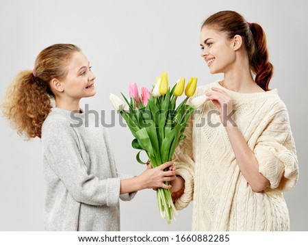 Girl tells mom bouquet of flowers for spring holidays