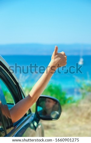 happy girl from car at sea greece background