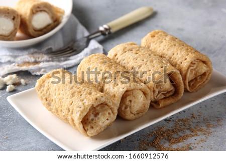 Concept of Russian cuisine. Breakfast. Pancakes with cottage cheese on a white plate and a light grey background. Background image, copy space