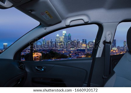 Looking through a car window with view of Philadelphia skyline at night as seen from the Stadium District, USA