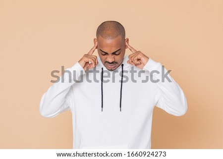 African guy with a white sweatshirt on a yellow background
