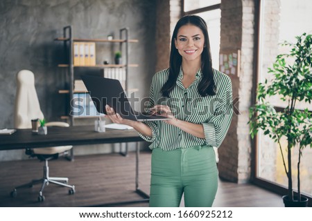 Photo of attractive latin business lady hold notebook chatting colleagues read report meet partners friendly person wear striped shirt green pants stand modern interior office indoors Royalty-Free Stock Photo #1660925212