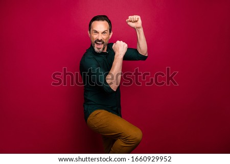 Photo of trendy shouting football fan wearing brown pants screaming after looking at score of football game isolated vivid color background