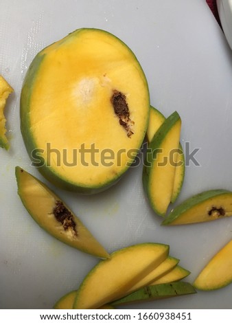 Ripe Mango fruit which is rotten and has whole worms 