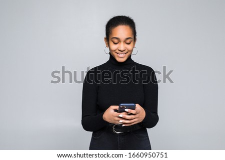 Beautiful woman happy with her smart phone isolated on a white background