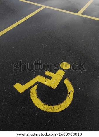 Handicapped parking spot at a local supermarket on a rainy day.