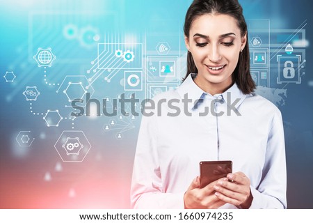 Smiling young businesswoman using smartphone over blurry blue background with double exposure of digital interface. Concept of big data and communication. Toned image