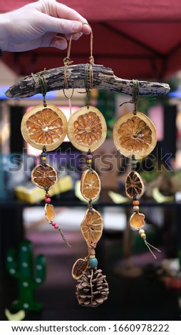 wind bell with orange and pine cone