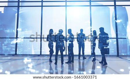 Silhouettes of business people in panoramic office with double exposure of blurry cityscape. Concept of business meeting and teamwork. Toned image