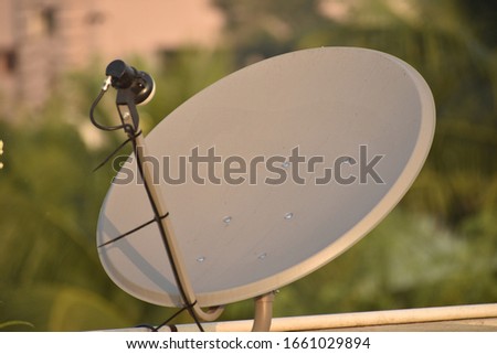 Installed dish or DTH or Direct to home tv on the roof against blur background, which is used for receiving TV programs.