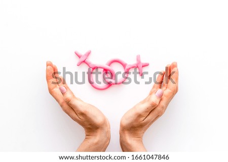 LGBT concept. Female Venus symbols in hands on white background top-down copy space
