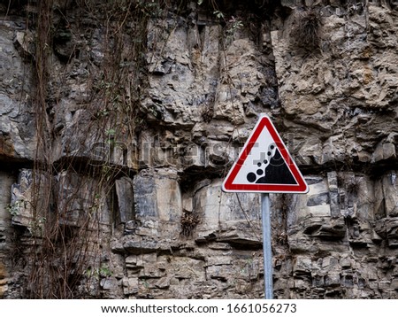 Rockfall sign on a rock background