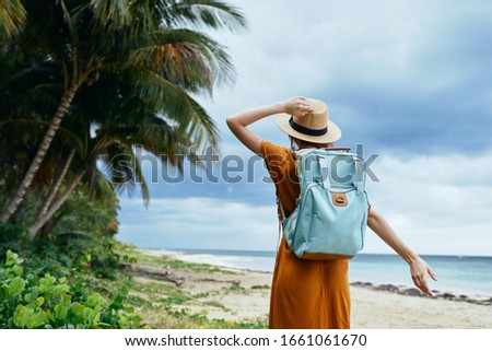 Woman tourist backpack hat palm travel Caribbean islands fresh air landscape