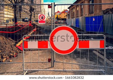 closed street is reconstructed,construction yard 
No entry sign 
traffic restrictions closure barriers