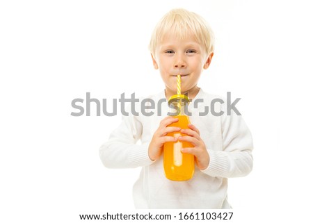 Little beautiful boy with blonde hair drinks juice, picture isolated on white background
