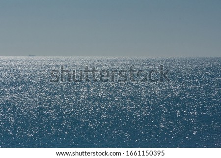 Very beautiful Golden highlights from the sun on the surface of the blue sea.