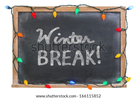 Winter Break hand drawn in white chalk on a black chalkboard surrounded by colorful holiday lights isolated on white