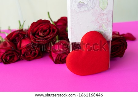 red heart and Red Rose petals on pink color background,