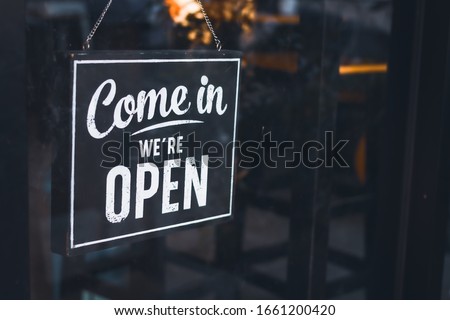 Welcome open sign on shop door .vintage tone stye. Royalty-Free Stock Photo #1661200420