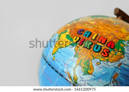 inscription in colored letters China virus on a world globe. Coronavirus epidemic concept in China. World Economy Recession Concept