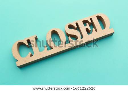 "closed" wooden sin board with blue background. restaurant sign board.