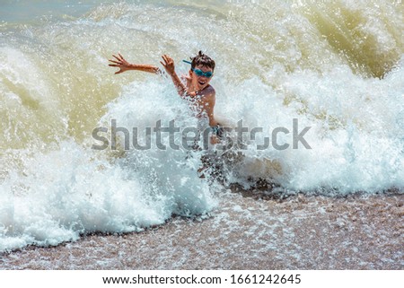 Boys playing with waves of the Black Sea, Summer and holidays in Romania