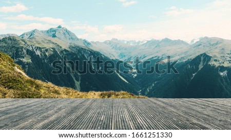 Terrace with a wonderful view. Panorama with imposing mountains and a blue sky. Live in the mountains. Austria