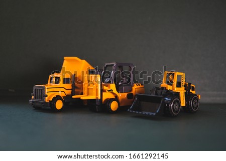 Closeup group of construction vehicle on dark background