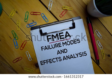 FMEA - Failure Modes and Effects Analysis write on a paperwork isolated on wooden background. Royalty-Free Stock Photo #1661312317