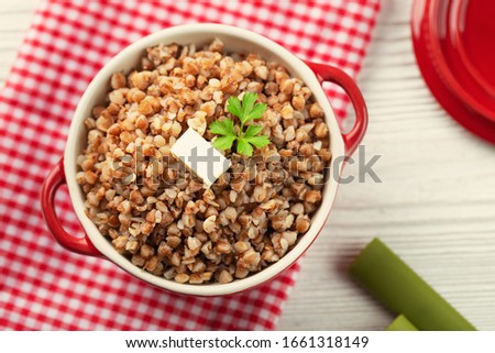Buckwheat porridge with butter in bawl - breakfast, healthy food. Top view Royalty-Free Stock Photo #1661318149