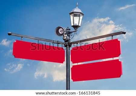 blank signs pointing over a sky background